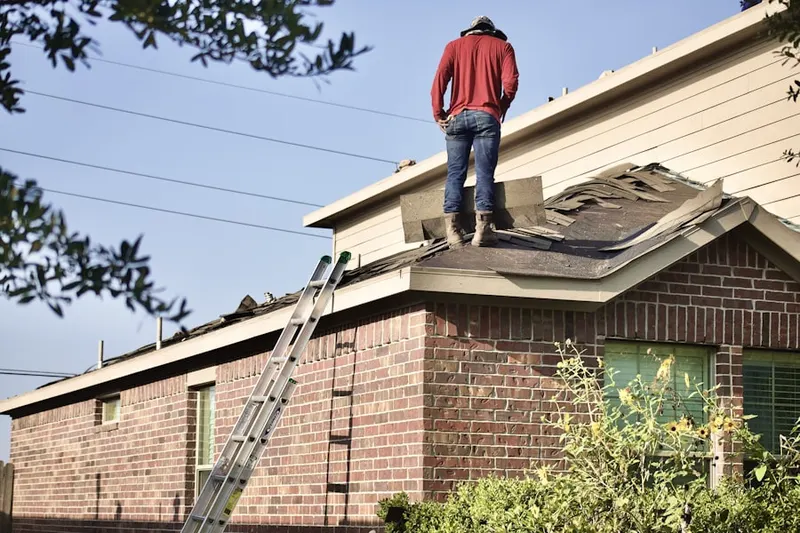 Professional roofer working on a residential roof in Dairy Manor Farms